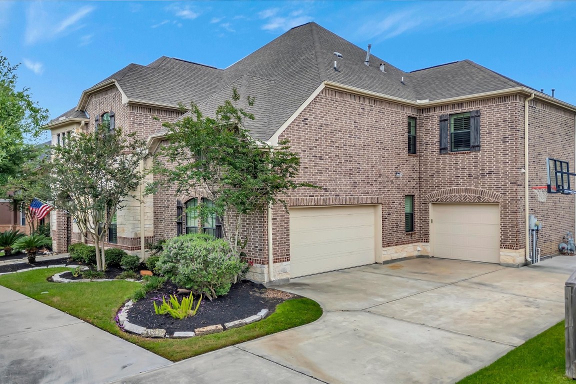 3108 Tyler Court Friendswood, TX 77546 - Photo 49 of 50 a front view of a house with a garden and plants