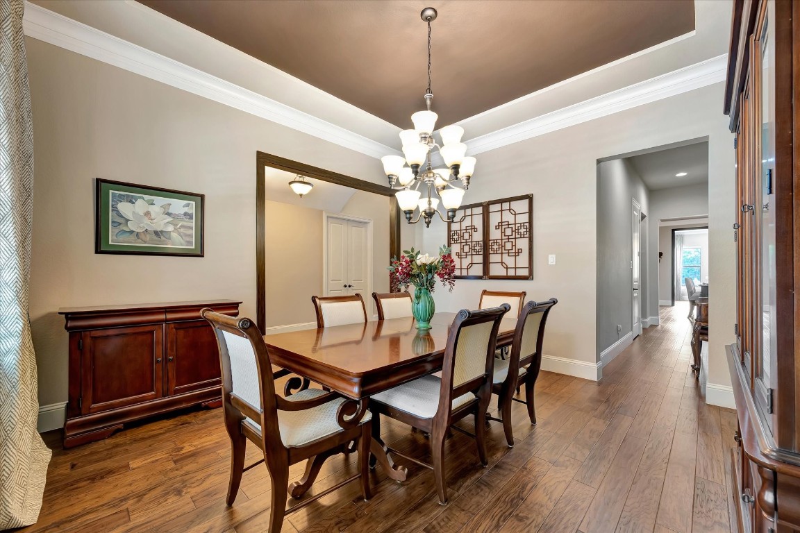 3108 Tyler Court Friendswood, TX 77546 - Photo 9 of 50 a dining room with furniture a chandelier and wooden floor