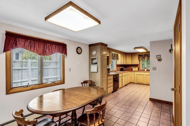 9 Uncle Henrys Road Mashpee, MA 02649 - Photo 17 of 41 a kitchen with stainless steel appliances granite countertop a stove a refrigerator a kitchen island a dining table and chairs with wooden floor