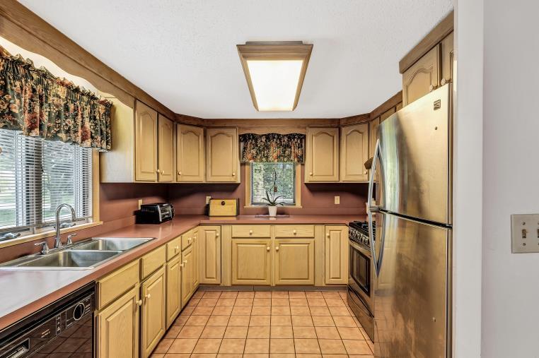 9 Uncle Henrys Road Mashpee, MA 02649 - Photo 18 of 41 a kitchen with a sink a refrigerator and cabinets