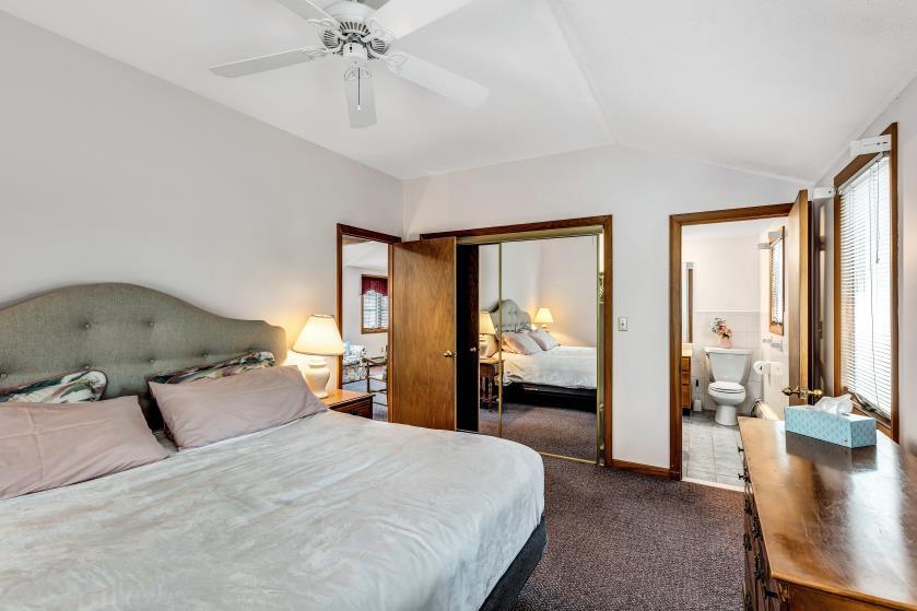 9 Uncle Henrys Road Mashpee, MA 02649 - Photo 26 of 41 a bedroom with a large bed and a chandelier