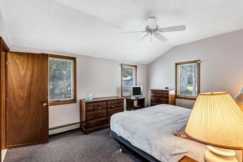 9 Uncle Henrys Road Mashpee, MA 02649 - Photo 27 of 41 a bed room with a bed and a chandelier