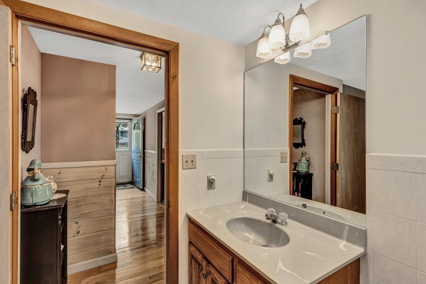 9 Uncle Henrys Road Mashpee, MA 02649 - Photo 28 of 41 a bathroom with a sink a mirror and a shower