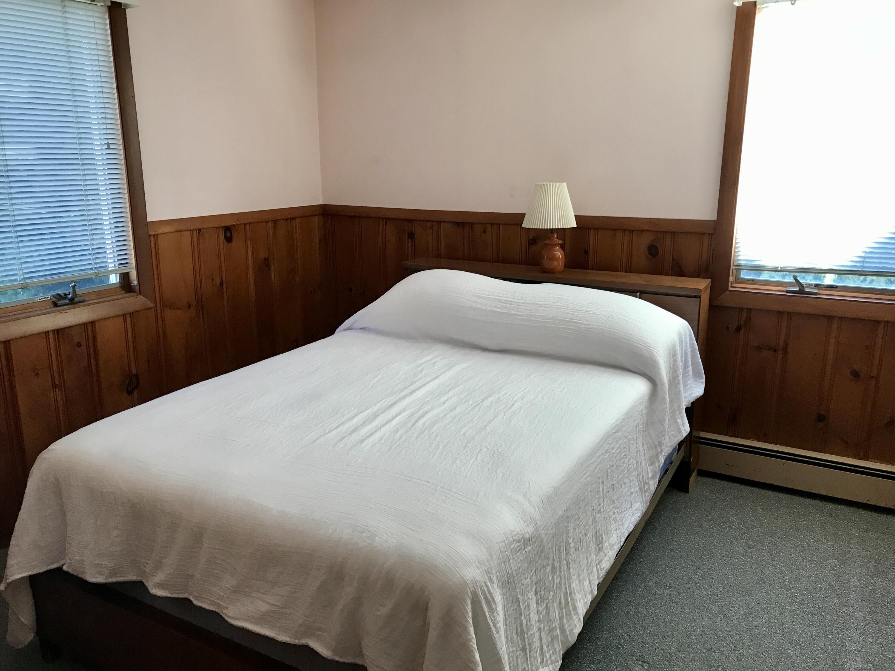 9 Uncle Henrys Road Mashpee, MA 02649 - Photo 32 of 41 a large bed sitting in a bedroom next to a window