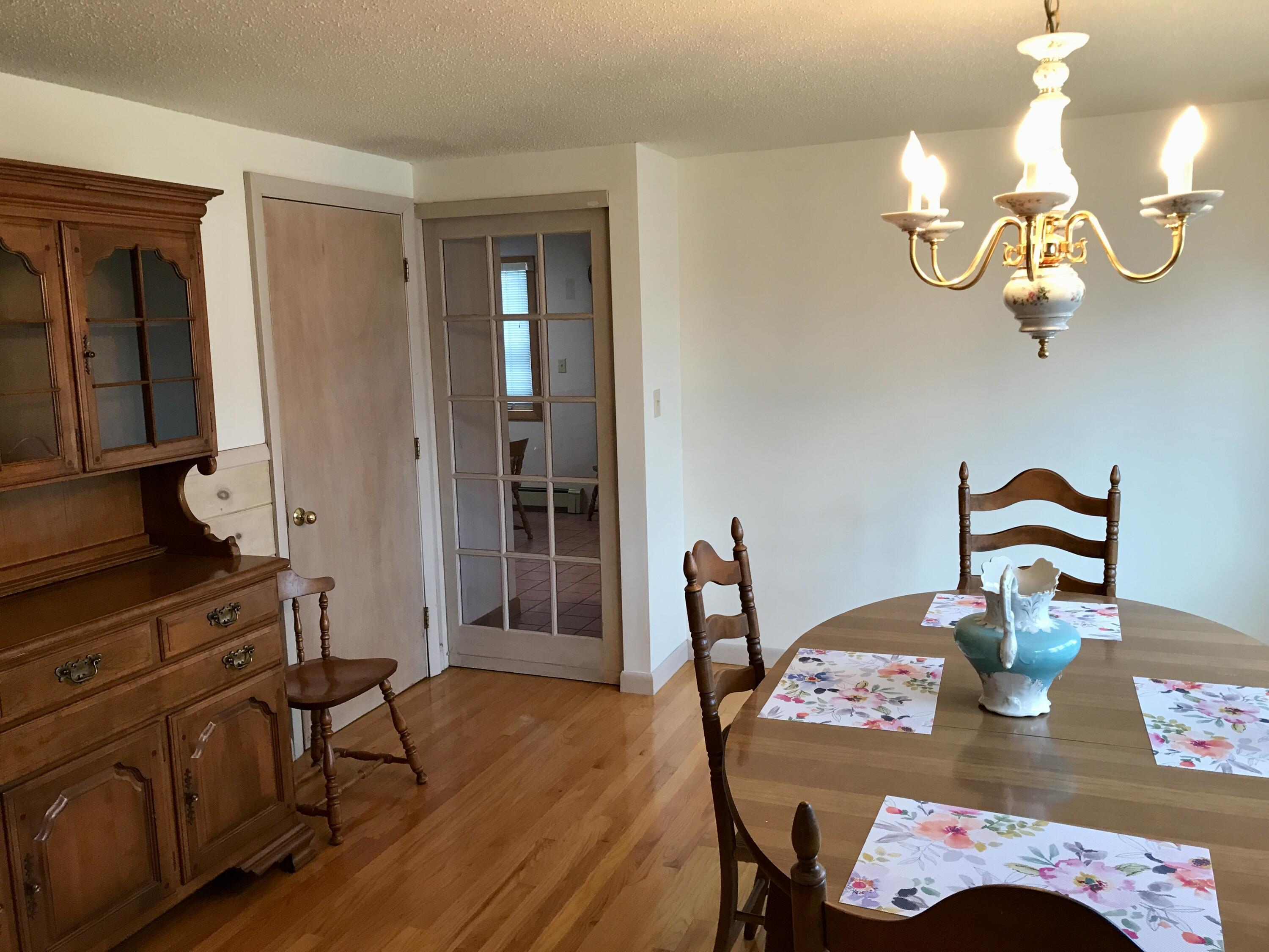 9 Uncle Henrys Road Mashpee, MA 02649 - Photo 6 of 41 a view of a dining room with furniture a chandelier and wooden floor