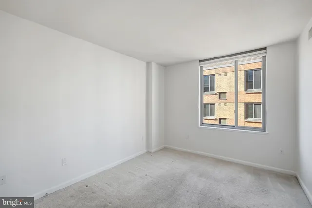a view of walk in closet with empty racks