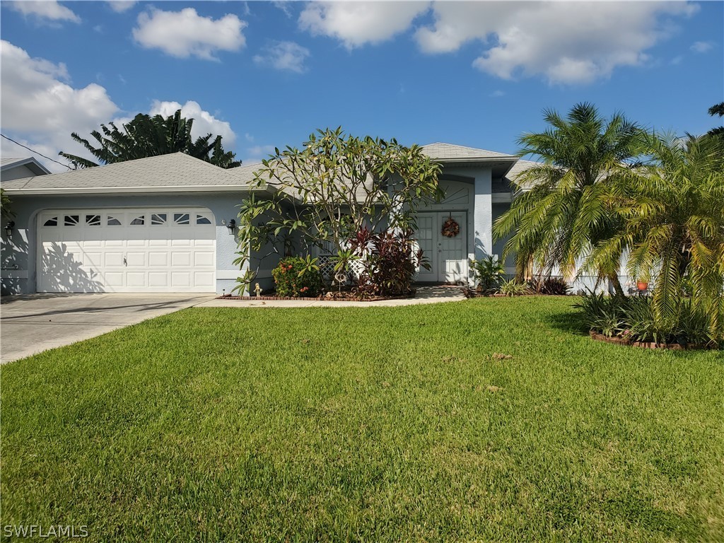a front view of a house with a yard and palm tree