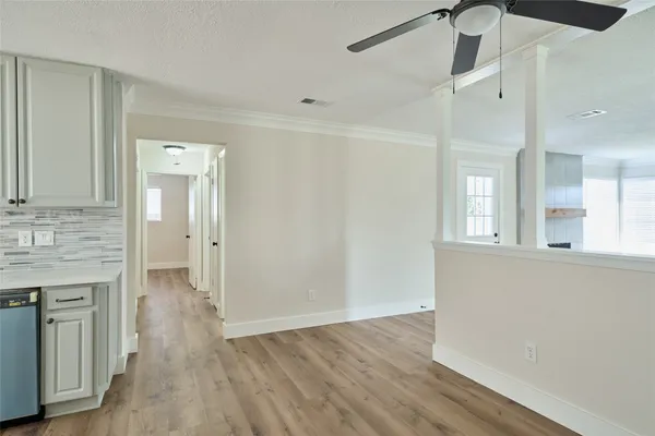 a view of a kitchen cabinets and wooden floor