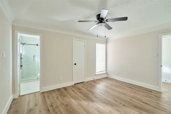 a view of room with hardwood floor and ceiling fan