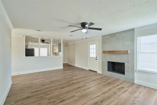 a view of an empty room with window and fire place