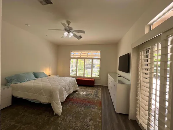 a bedroom with bed and window