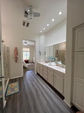 a large room with a lot of counter space and wooden floor