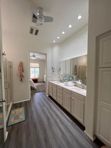 a large room with a lot of counter space and wooden floor