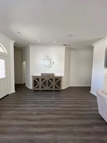 a view of a room with wooden floor