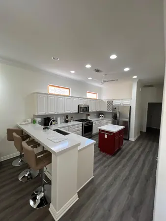 a large kitchen with a table and chairs in it