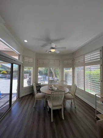 a dining room with furniture and wooden floor