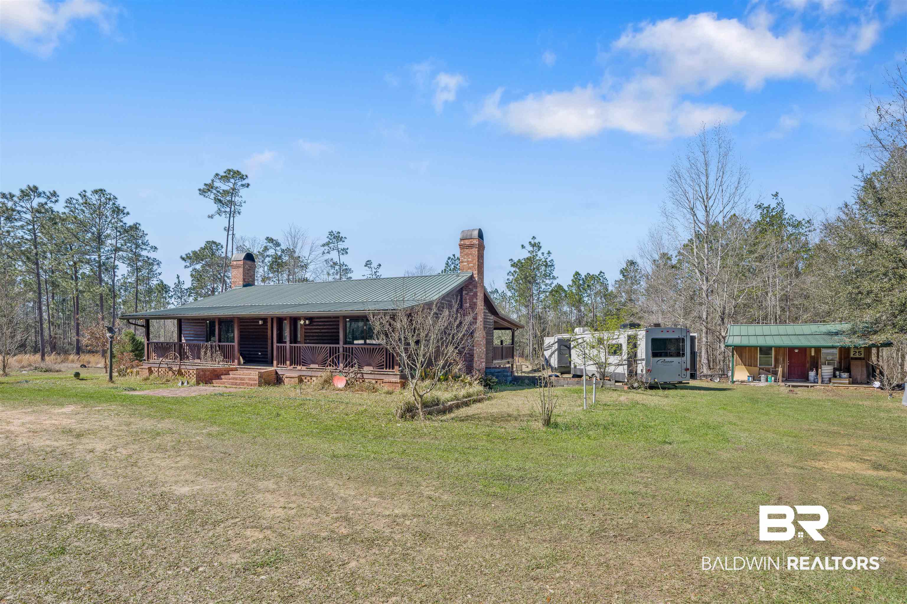 51699 Highway 31 Perdido, AL 36562 - Photo 4 of 30 Exterior space with covered porch, a chimney, metal roof, and a front yard
