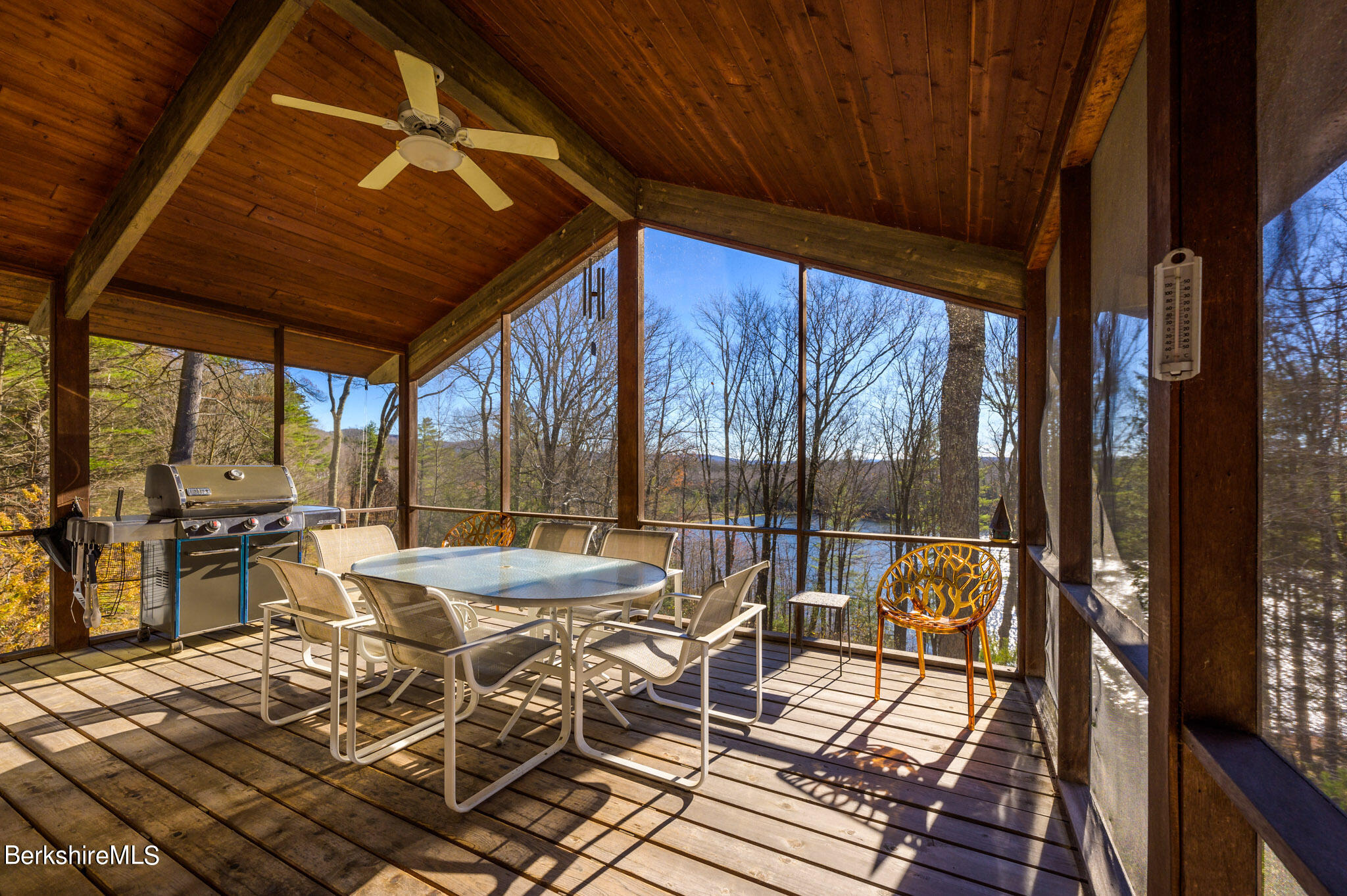 140 Main Road Monterey, MA 01230 - Photo 14 of 48 a view of a patio with table and chairs and wooden floor