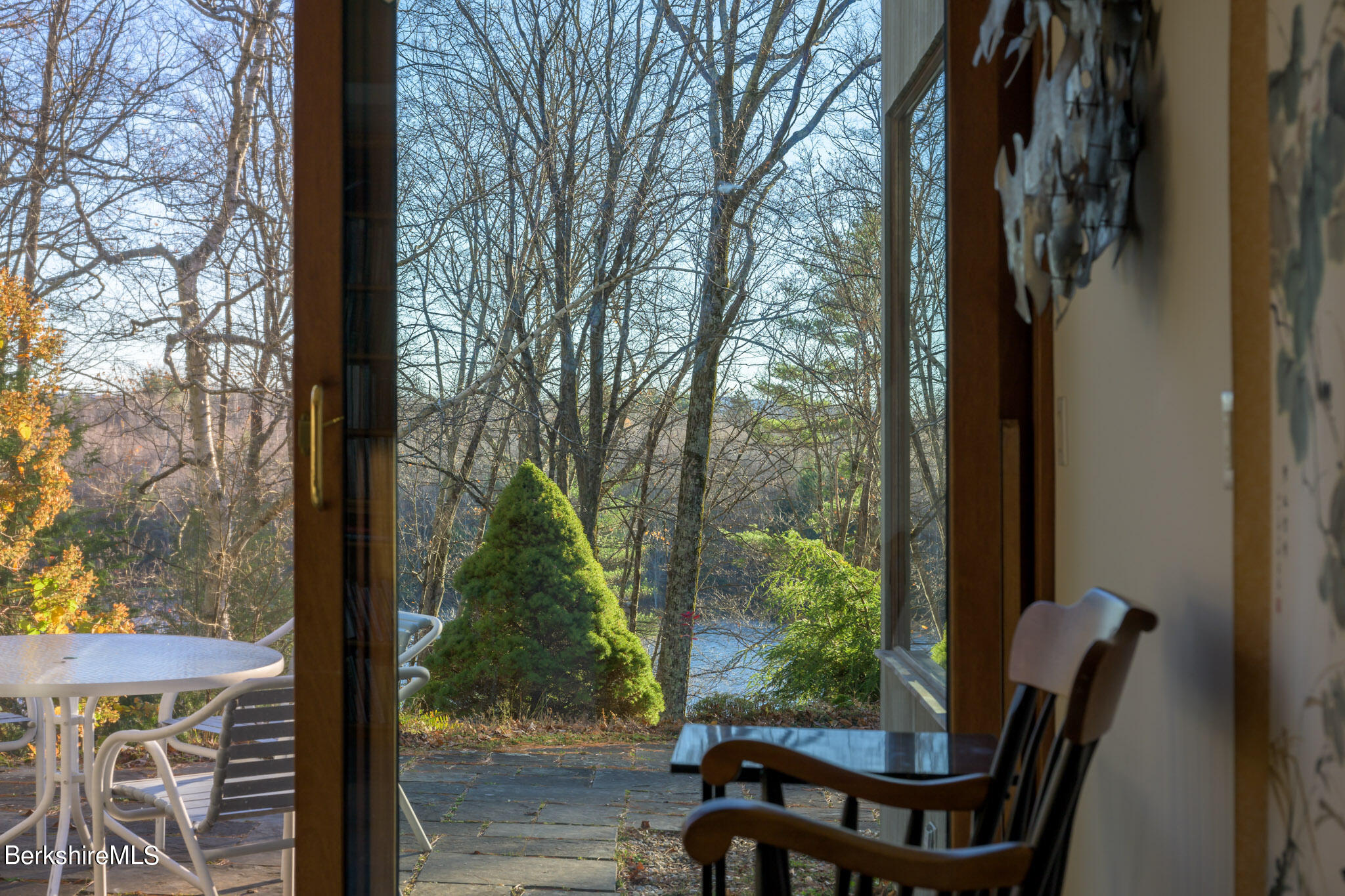140 Main Road Monterey, MA 01230 - Photo 39 of 48 a view of a patio with table and chairs and wooden floor