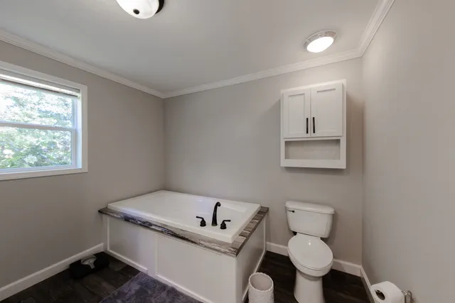 a white toilet sitting next to a bathroom sink
