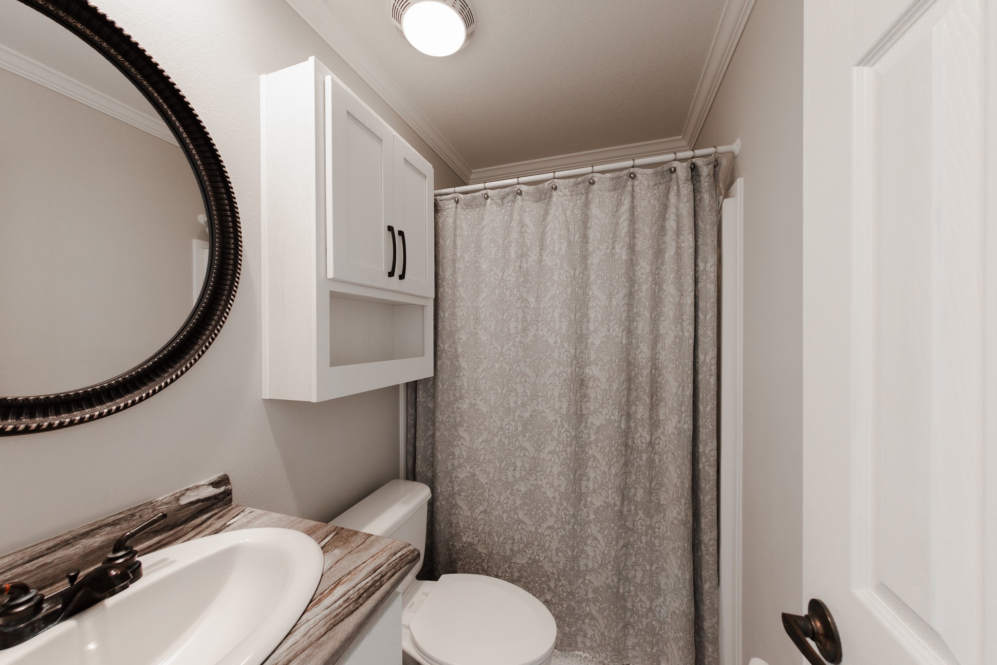 307 Swiss Colony Road Hohenwald, TN 38462 - Photo 17 of 35 a bathroom with a sink mirror and toilet