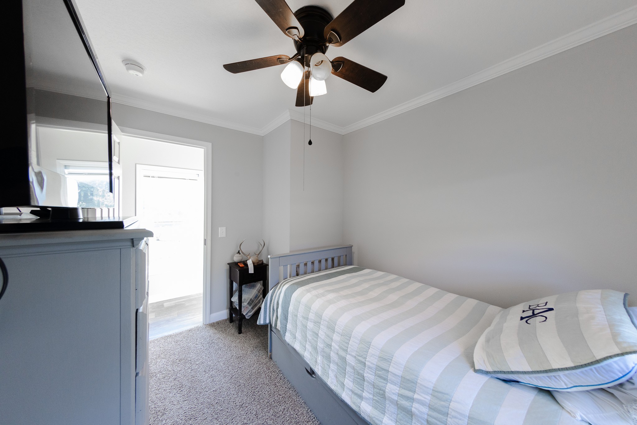 307 Swiss Colony Road Hohenwald, TN 38462 - Photo 18 of 35 a bedroom with a bed and a chandelier