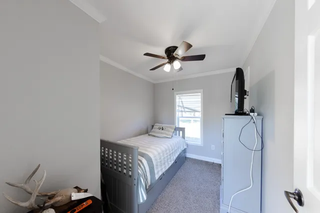 a bedroom with a bed and a chandelier