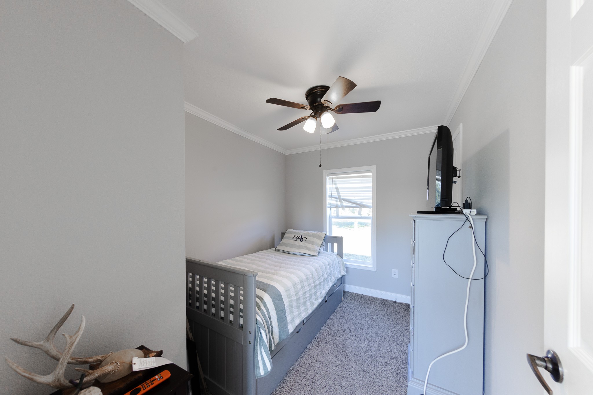 307 Swiss Colony Road Hohenwald, TN 38462 - Photo 19 of 35 a bedroom with a bed and a chandelier