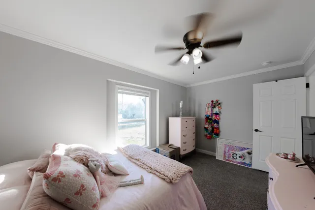 a bedroom with a bed furniture and a window