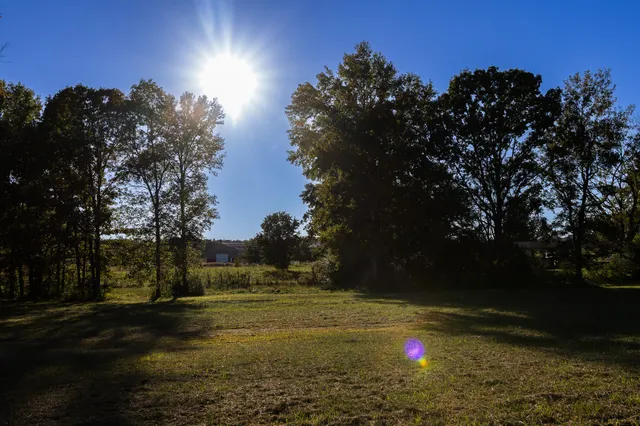 a view of a house with swimming pool and sitting area