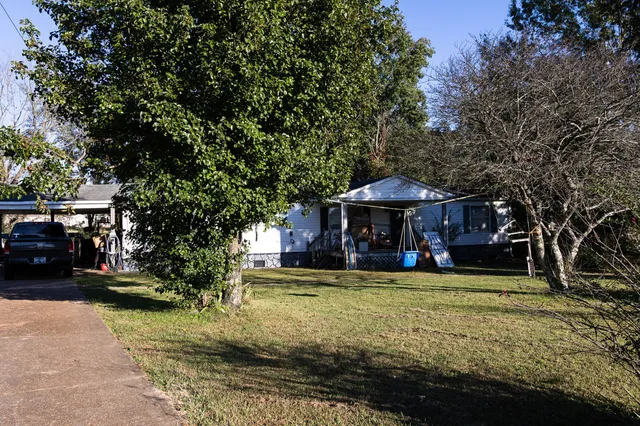 a view of a field with trees in the background