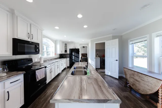 a large kitchen with kitchen island granite countertop lots of counter top space