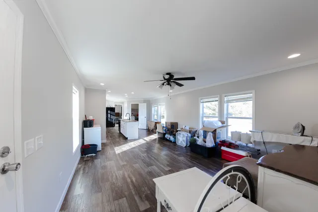 a living room with furniture and a wooden floor