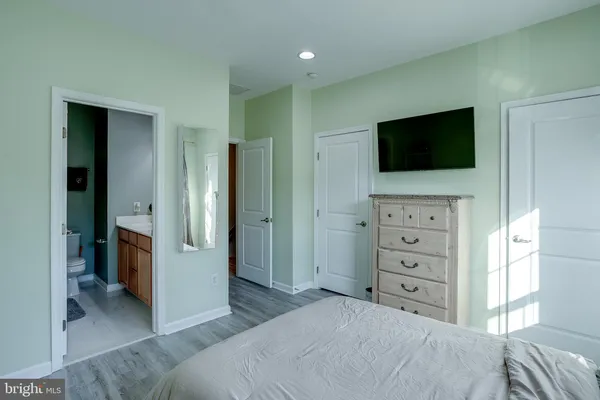 a bedroom with a bed and a television