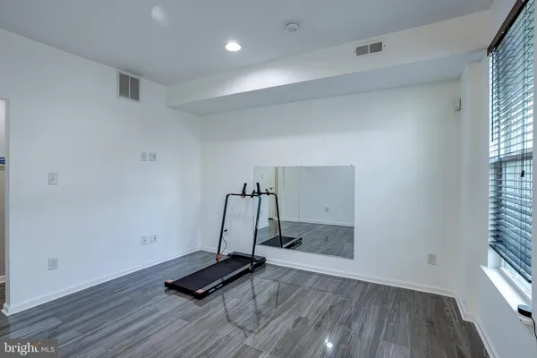 a view of a room with gym equipment and a window