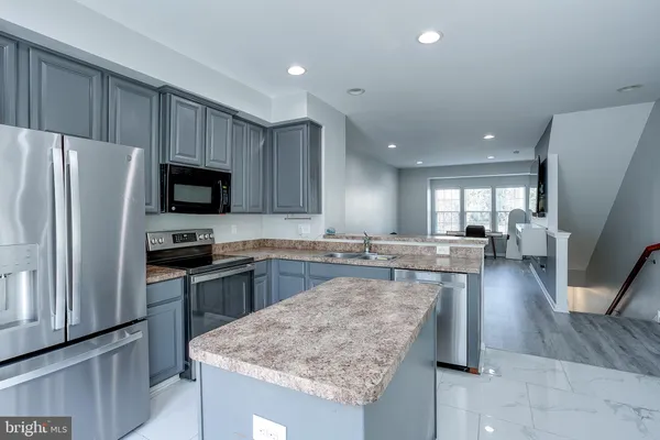 a kitchen with a sink stove and refrigerator