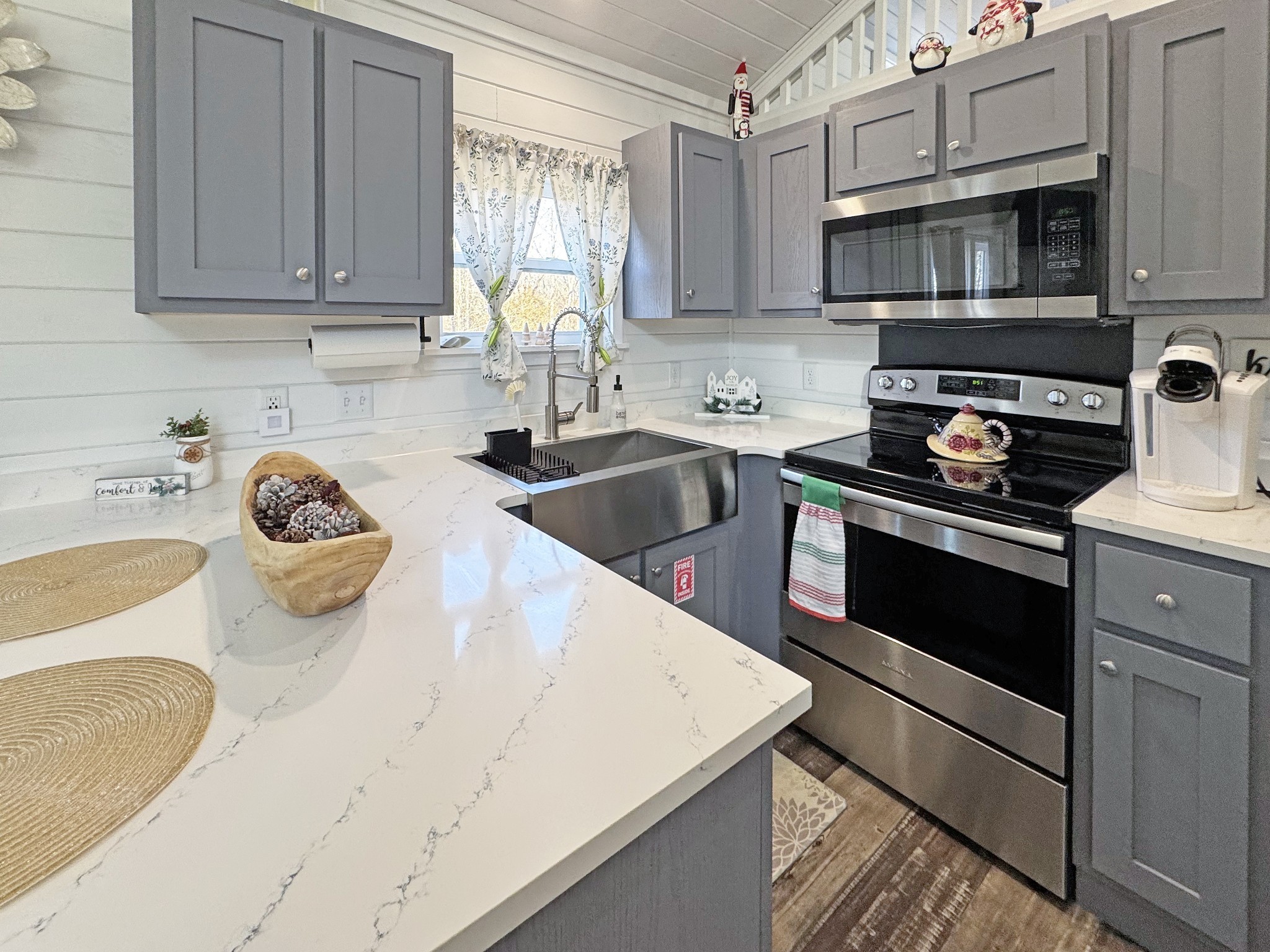 a kitchen with granite countertop a sink and stove top oven