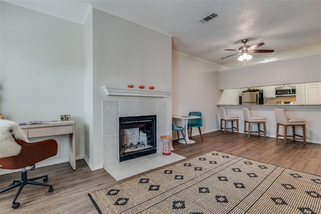6003 Oram Street, Unit 107 Dallas, TX 75206 - Photo 1 of 23 a living room with furniture and a fireplace
