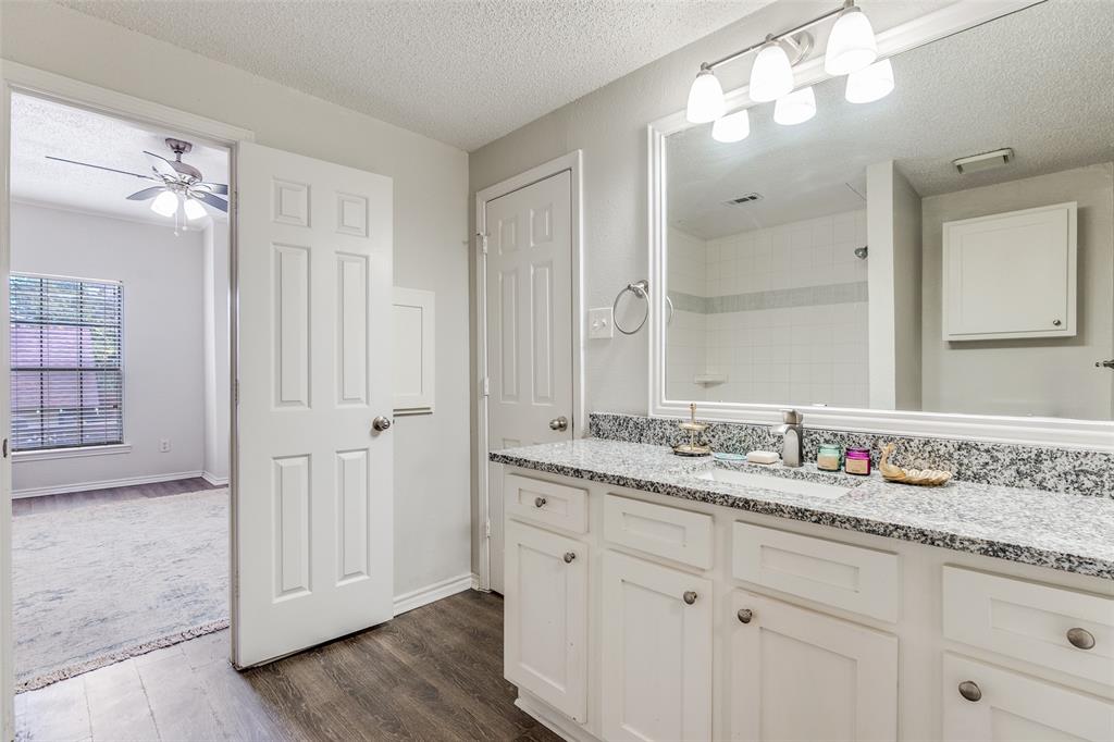 6003 Oram Street, Unit 107 Dallas, TX 75206 - Photo 13 of 23 a bathroom with a granite countertop double vanity sink mirror and