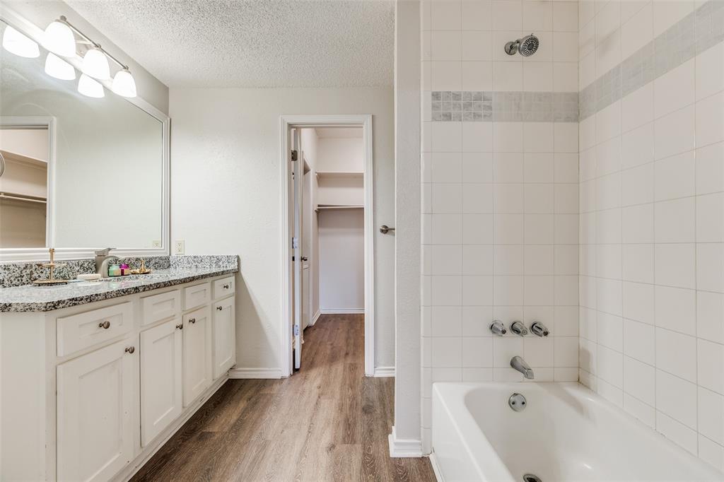 6003 Oram Street, Unit 107 Dallas, TX 75206 - Photo 14 of 23 a bathroom with a tub sink and mirror