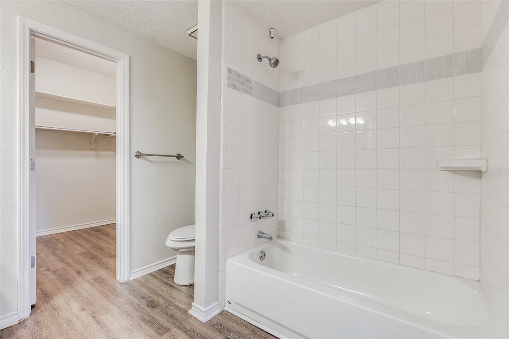 6003 Oram Street, Unit 107 Dallas, TX 75206 - Photo 15 of 23 a bathroom with a bathtub toilet and sink