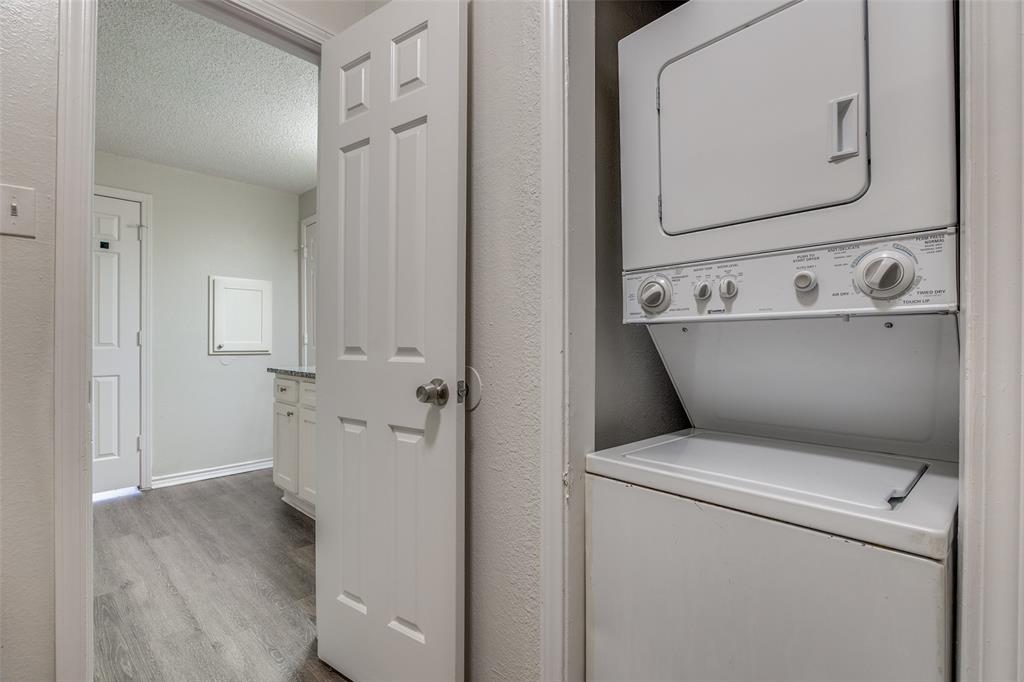 6003 Oram Street, Unit 107 Dallas, TX 75206 - Photo 18 of 23 a view of washer and dryer with wooden floor