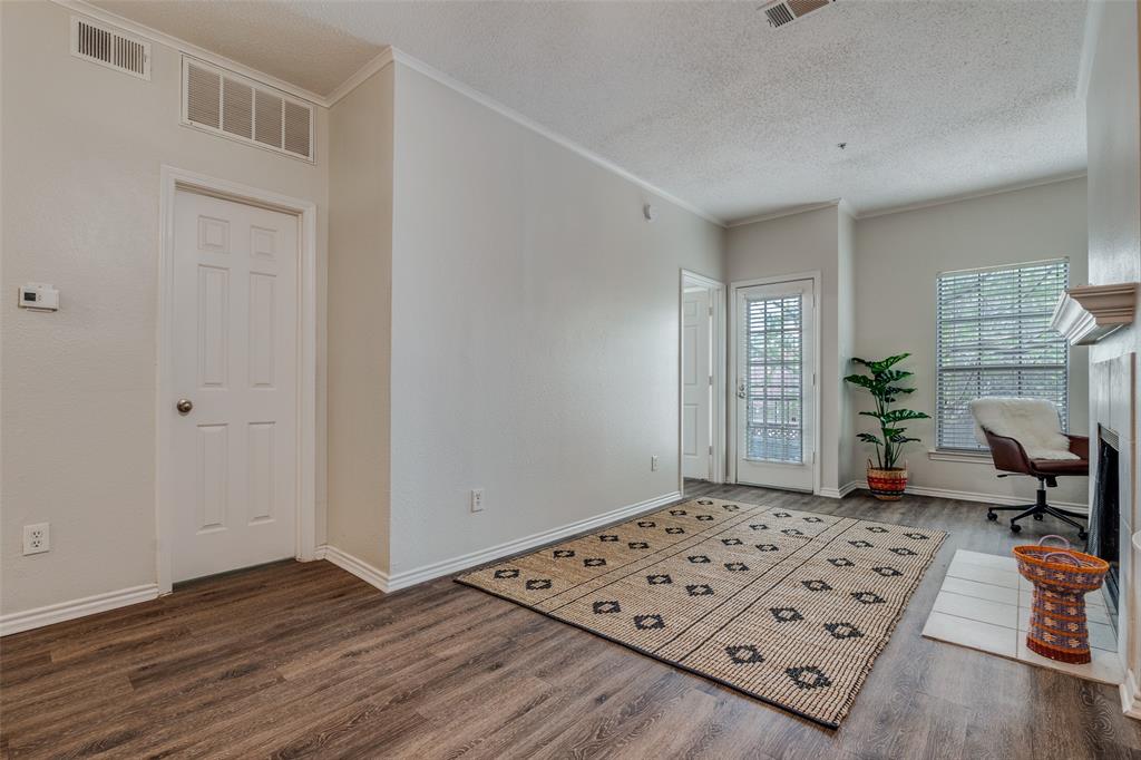 6003 Oram Street, Unit 107 Dallas, TX 75206 - Photo 3 of 23 a view of a livingroom with wooden floor and a window