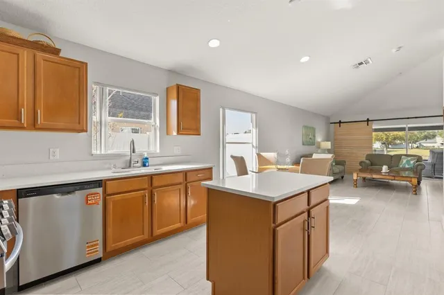 a kitchen with a sink stove and cabinets