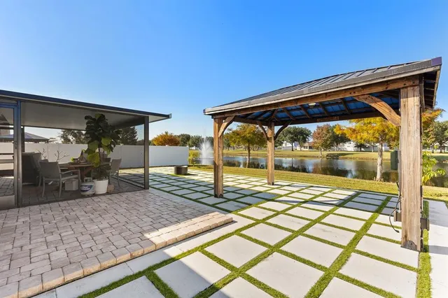 an aerial view of a house with a swimming pool patio and outdoor seating