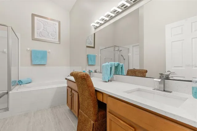 a bathroom with a granite countertop sink a toilet a mirror and bathtub