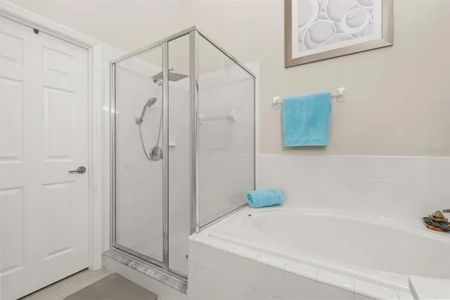 a white bath tub sitting next to a shower