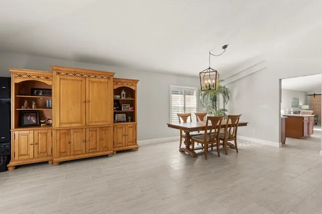 a view of a dining room with furniture and chandelier