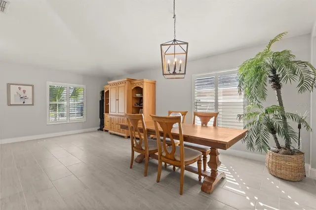 a dining room with furniture and window