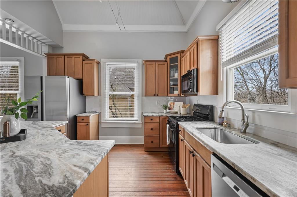2891 Macaw Street Northwest Atlanta, GA 30318 - Photo 11 of 26 a kitchen with a refrigerator stove microwave and sink